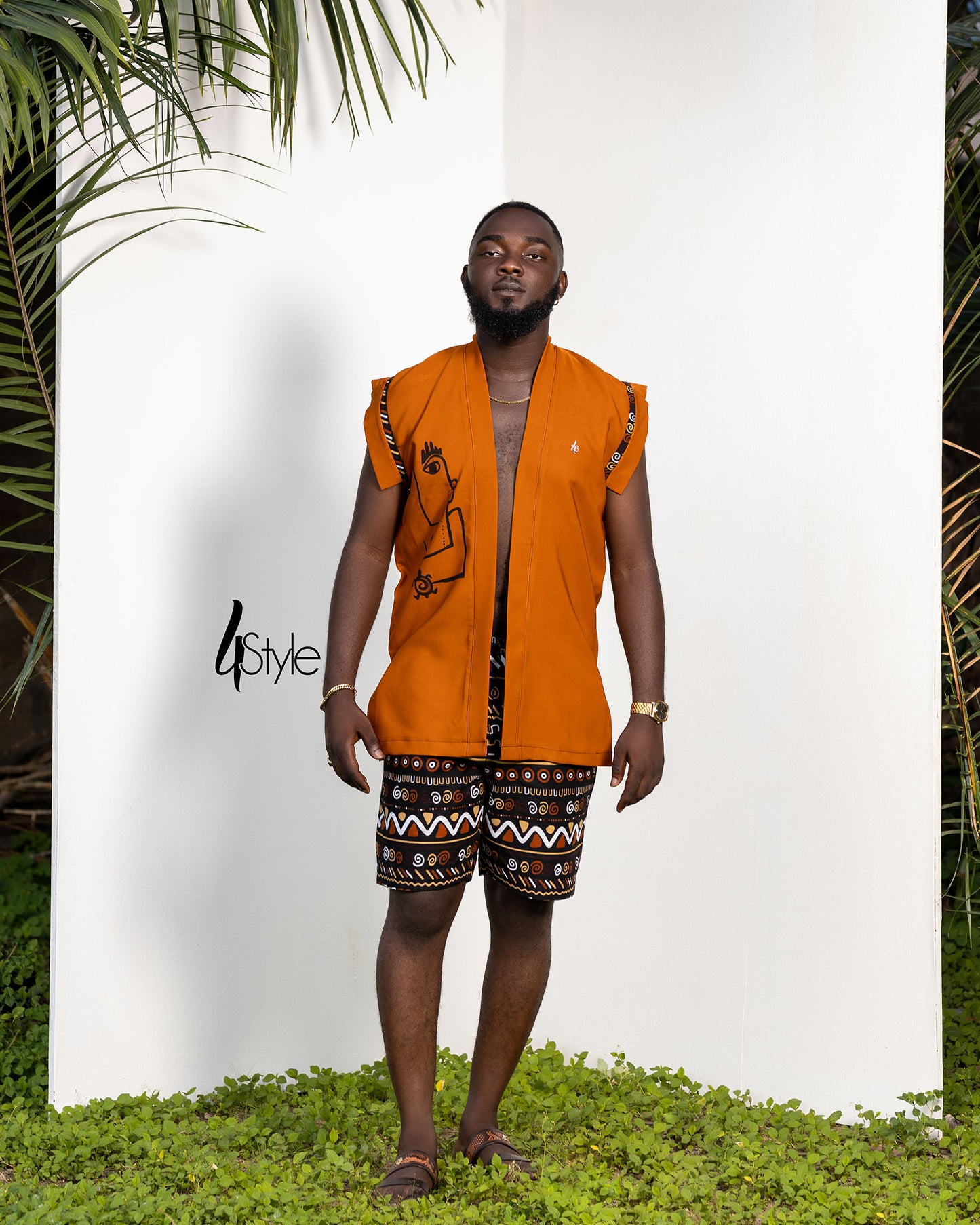 bent orange crepe to and African print shorts.